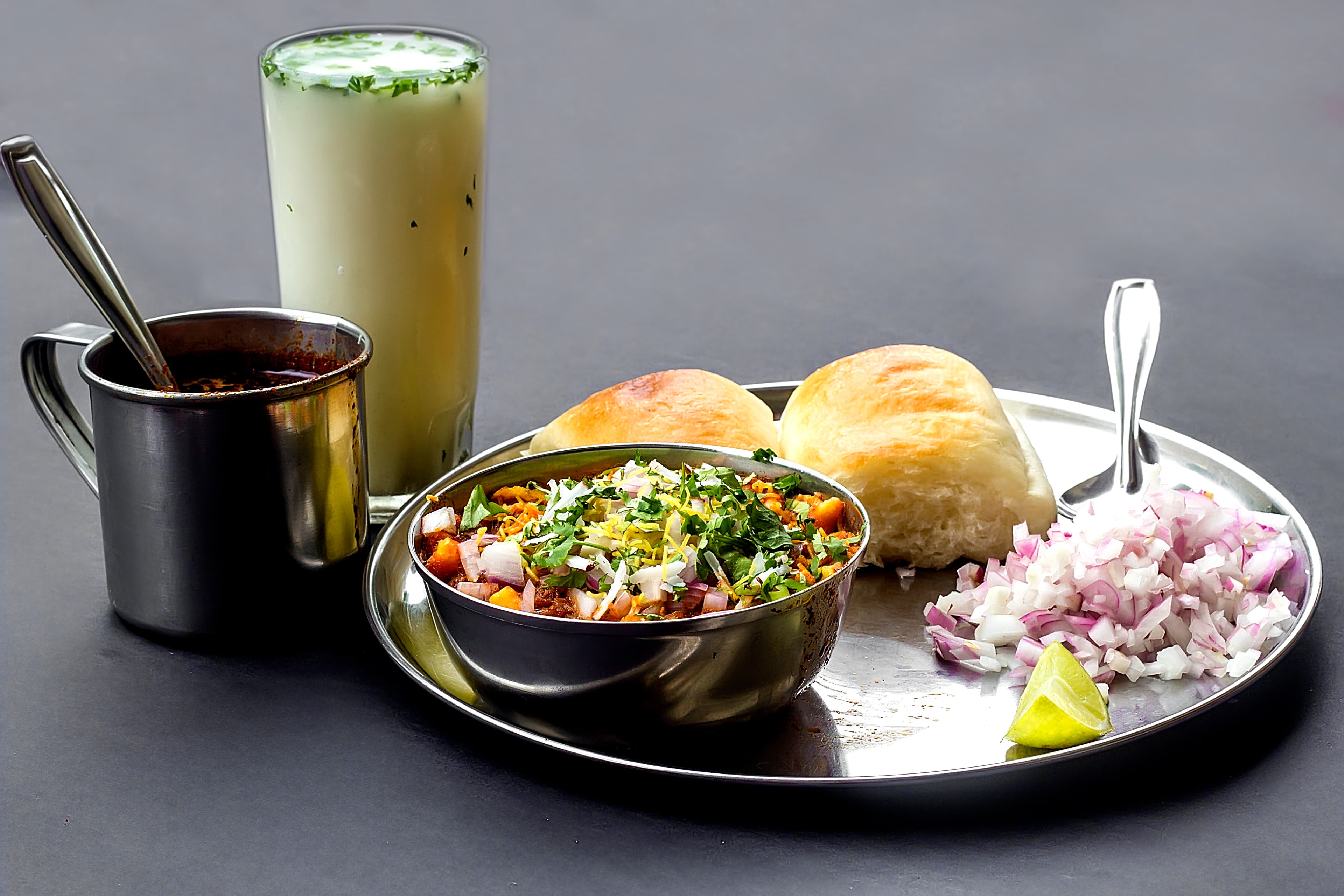 Misal pav — a indian breakfast dish from India — featuring vegetable curry-forward, layered toppings, bread-soaking format