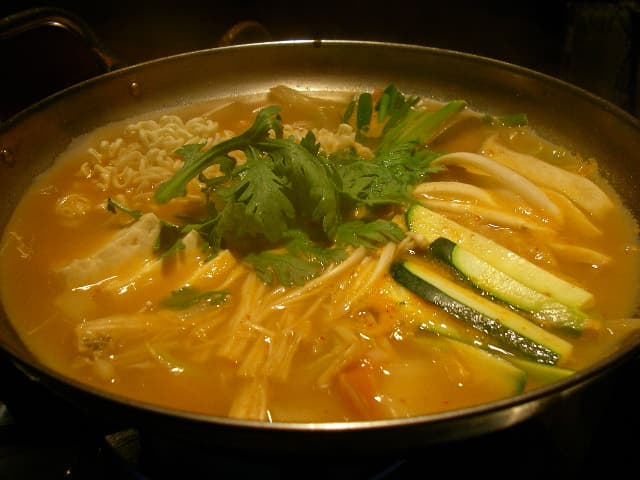 Jjigae — a korea cuisine main course dish from Korea — featuring deeply seasoned, communal pot, meat or seafood base