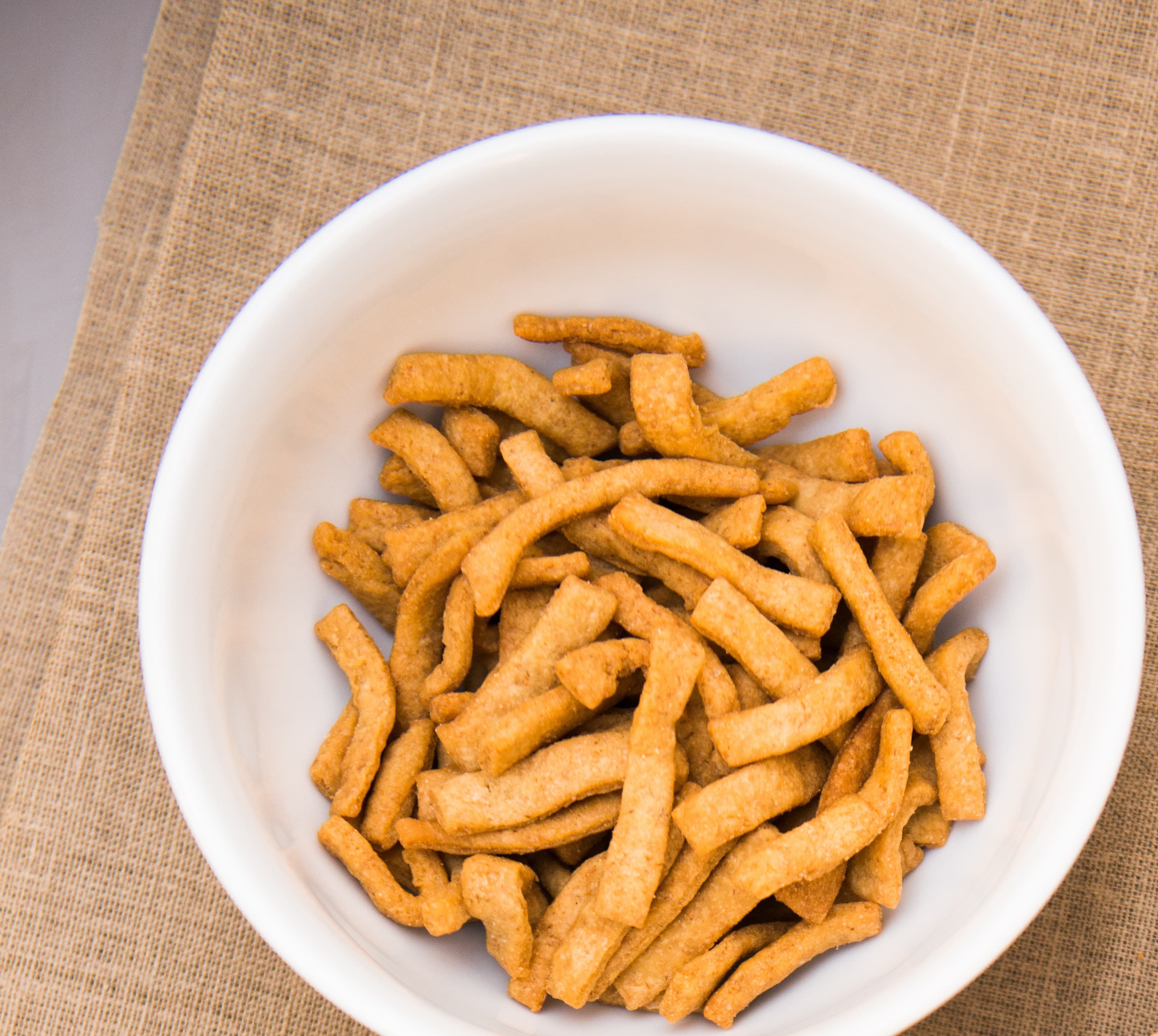 Chin chin — a nigerian snack dish from Nigeria — featuring fried dough squares, nutmeg-spiced, crunchy