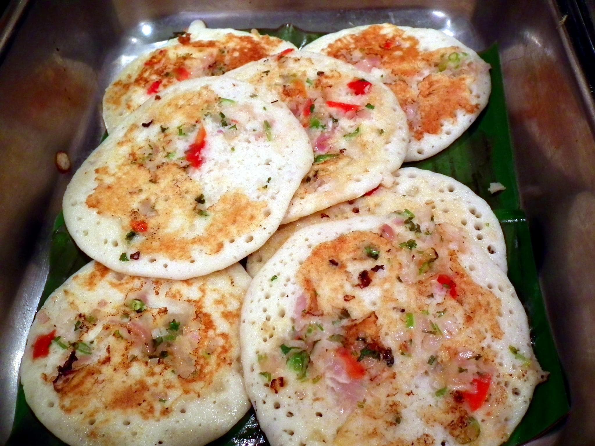 Uttapam — a indian breakfast dish from India — featuring thick and savory, vegetable-topped, flat-cooked