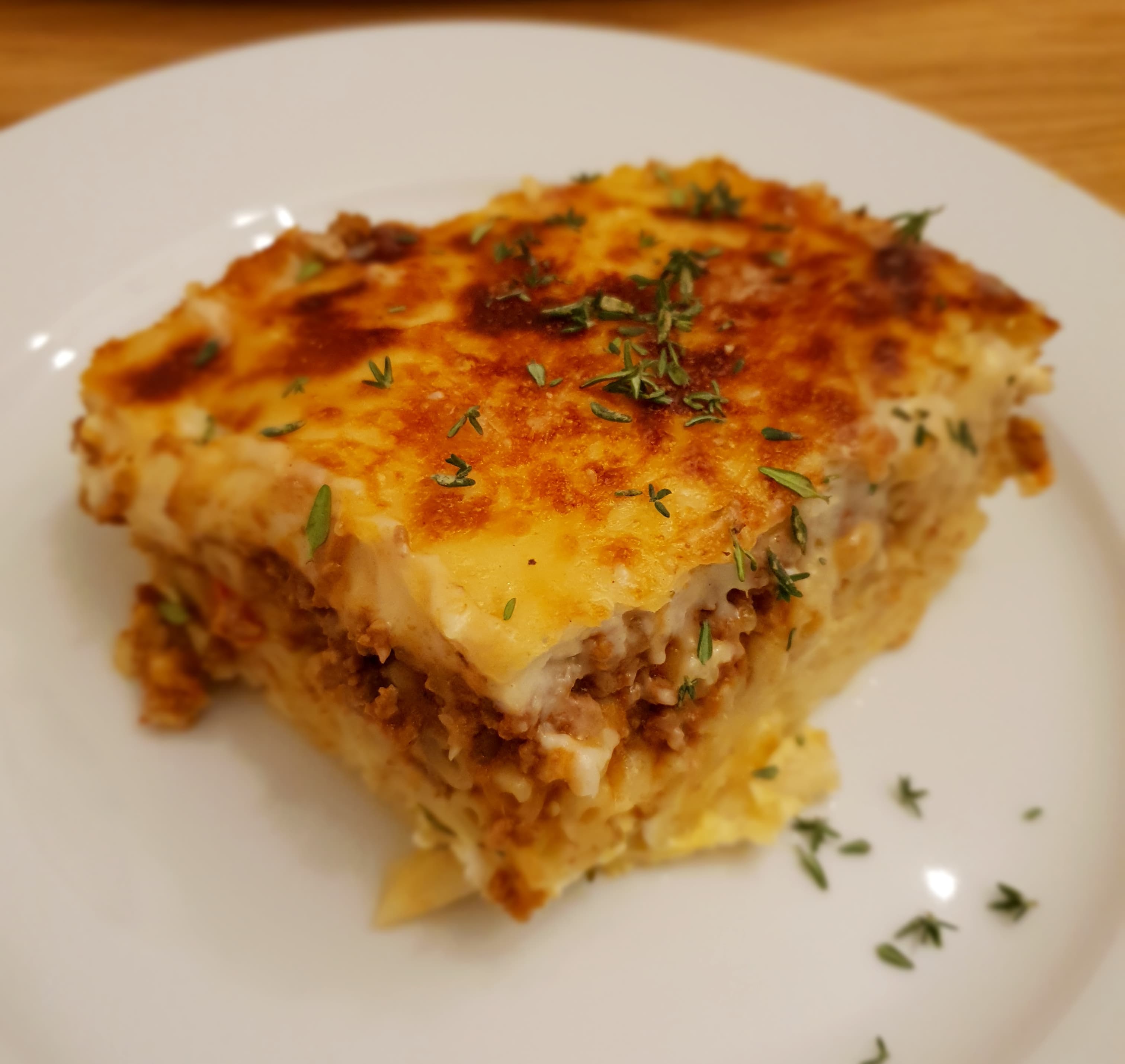 Pastitsio — a greek main course dish from Athens, Greece — featuring cinnamon spiced, bechamel crown, tube pasta