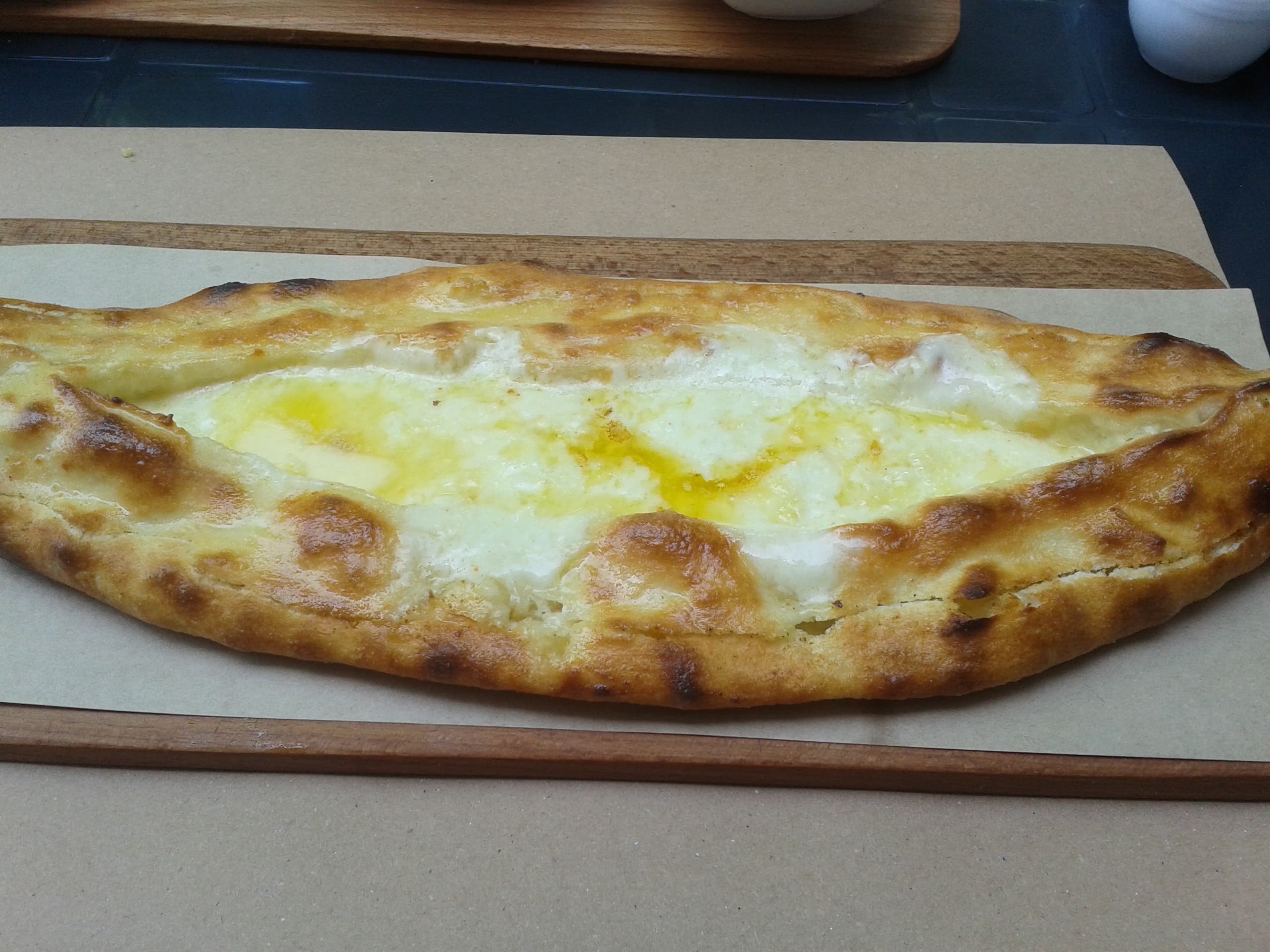 Peinirli — a turkish main course dish from Turkey — featuring boat-shaped, open pie, cheese-forward