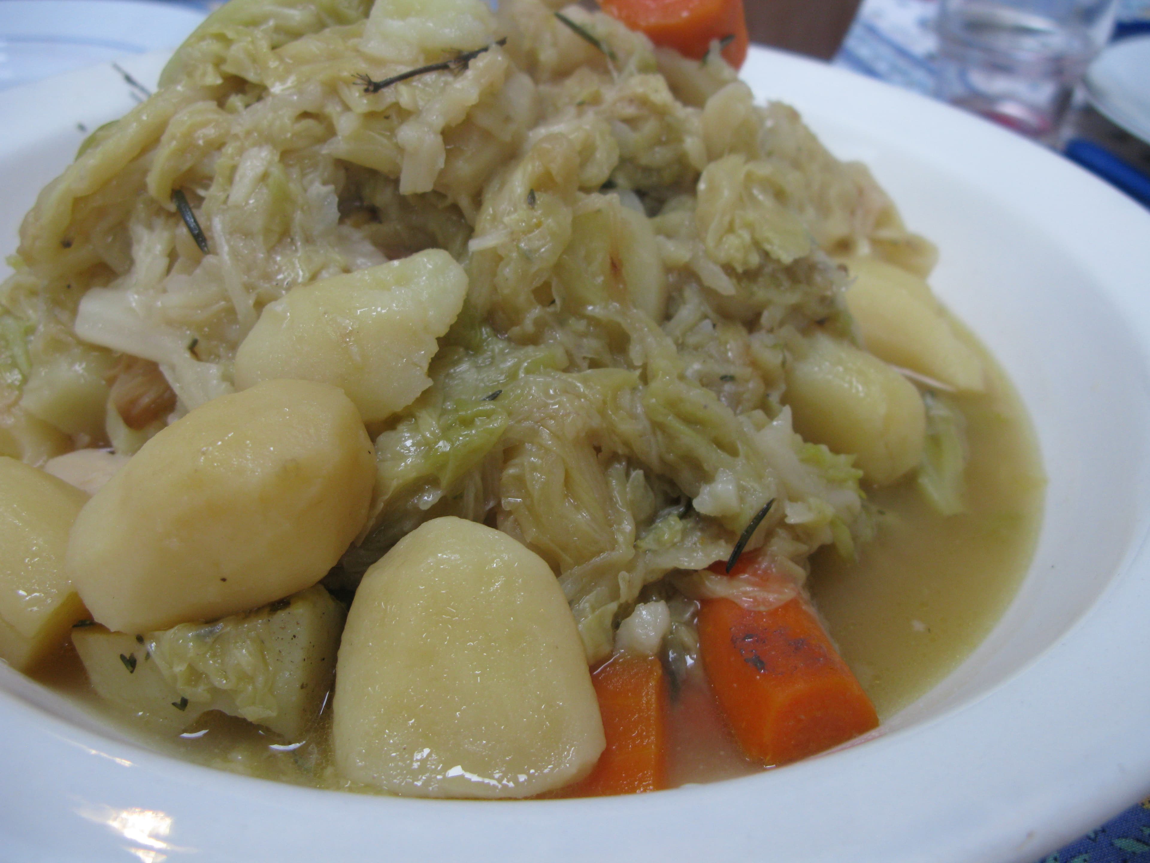 Potée — a french main course dish from France — featuring slow-cooked in stock, winter vegetables, pork-forward