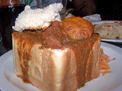 Bunny chow — a south african main course dish from South Africa — featuring bread-as-vessel, curry-forward, hand-held