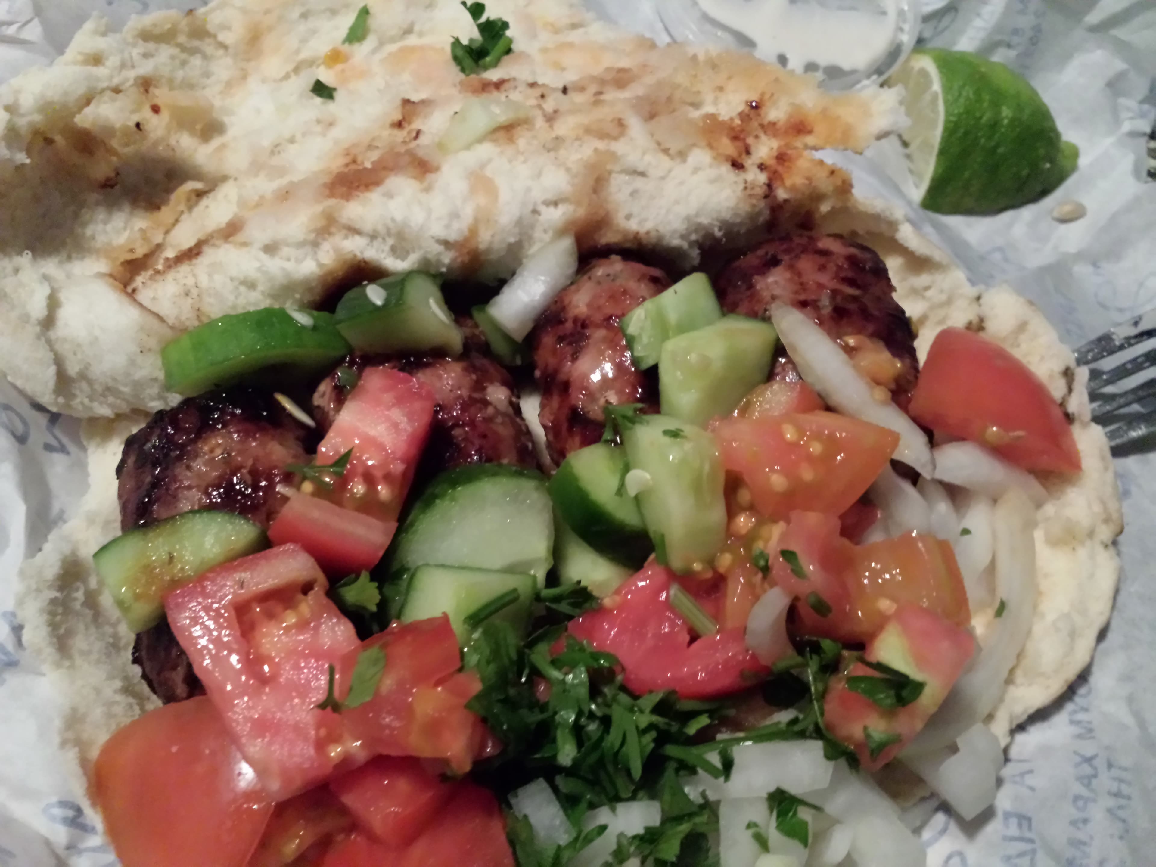 Sheftalia — a cypriot main course dish from Cyprus — featuring caul-fat wrapped, Cypriot staple, pinkish-hued