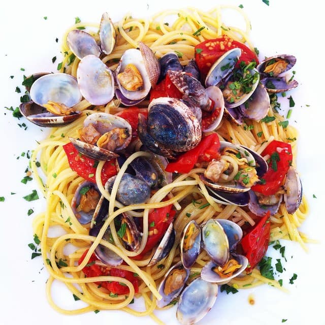 Spaghetti alle vongole — a italian main course dish from Italy — featuring briny and minimal, clam-forward, coastal Italian