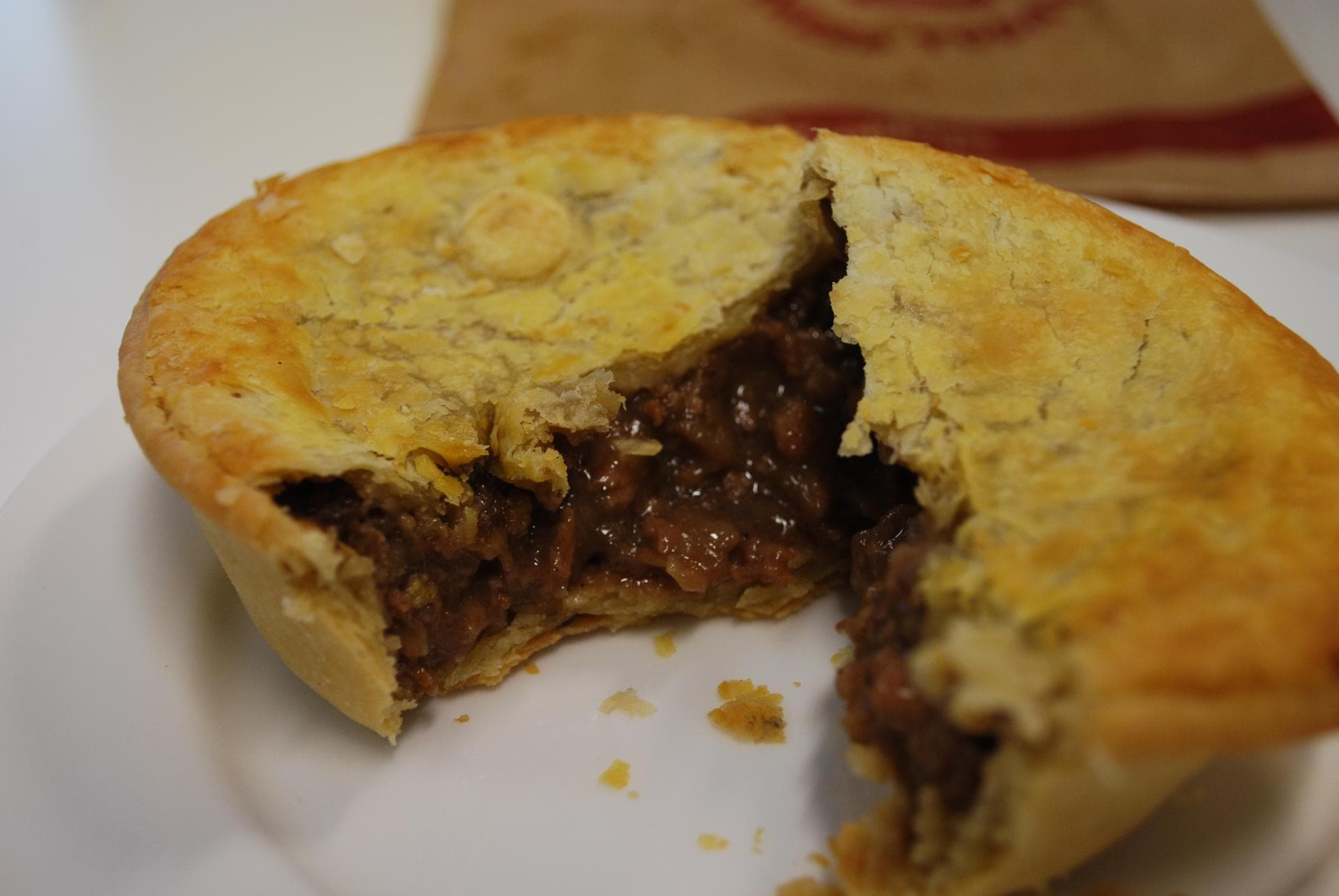 Steak pie — a british main course dish from United Kingdom — featuring stewing beef gravy, pastry-enclosed, chip shop staple