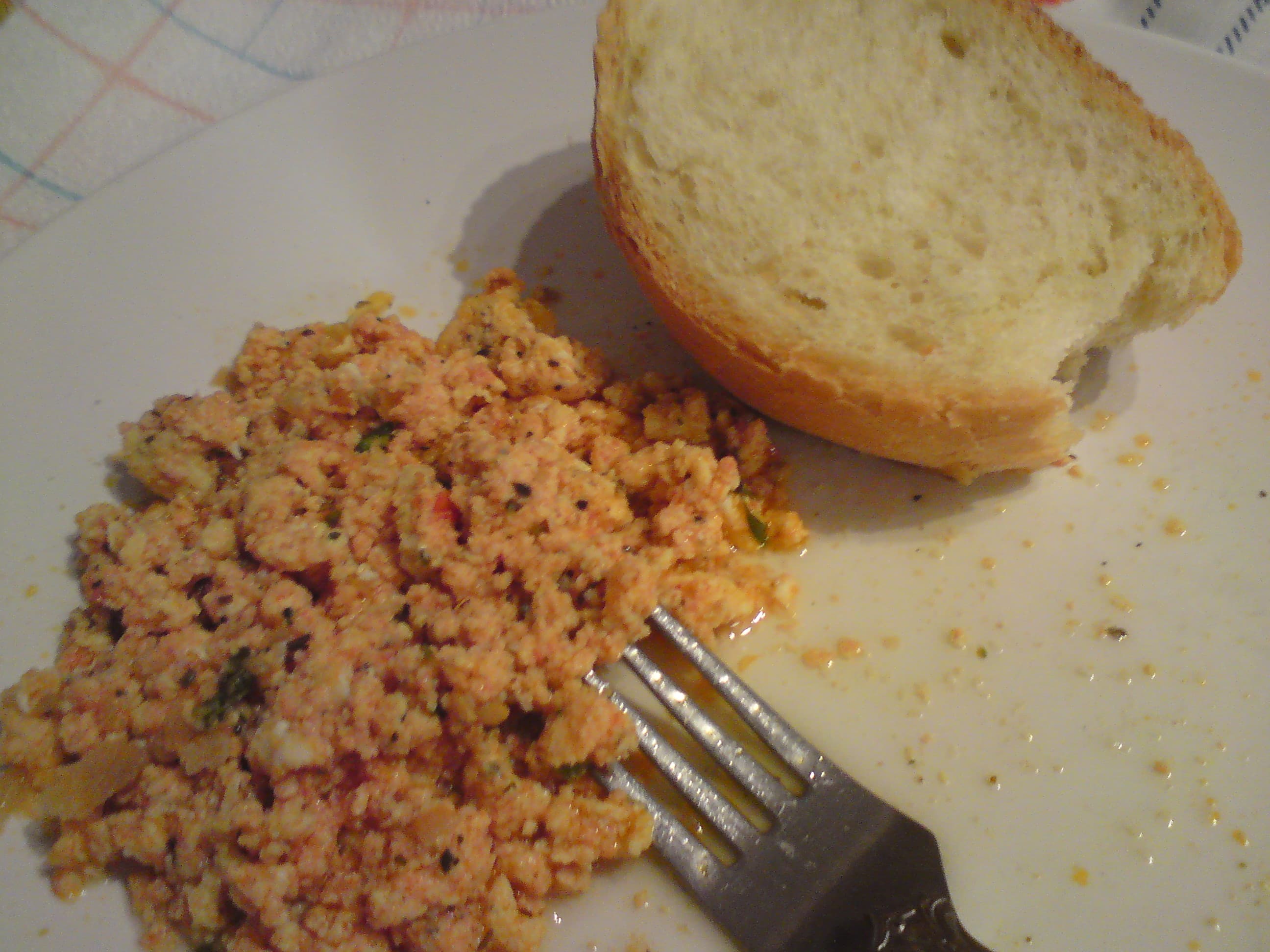 Strapatsada — a greek snack dish from Greece — featuring scrambled eggs, tomato-forward, olive oil base