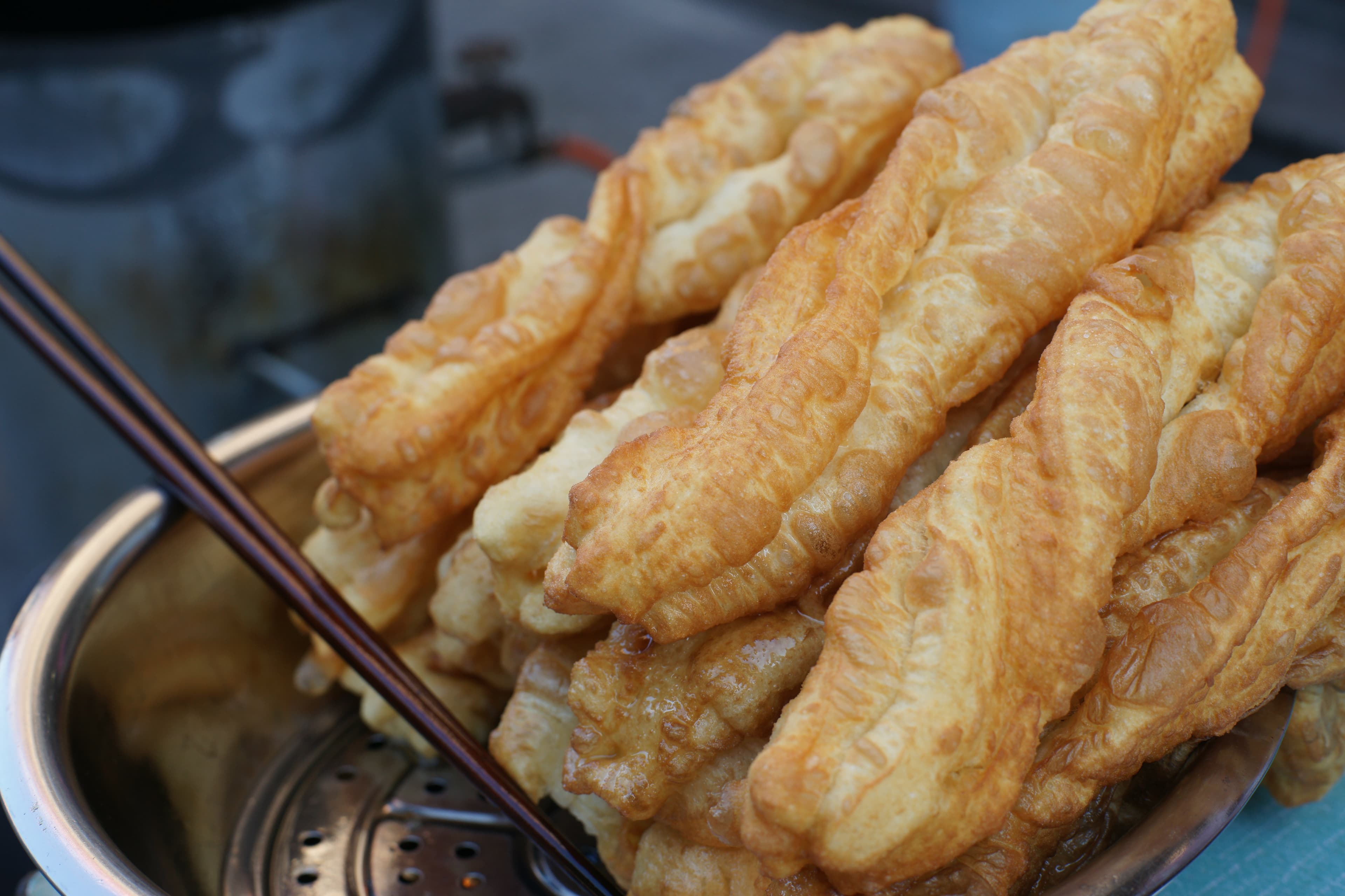 Youtiao — a people's republic of china cuisine breakfast dish from People's Republic of China — featuring deep-fried, wheat dough, hand-tearable
