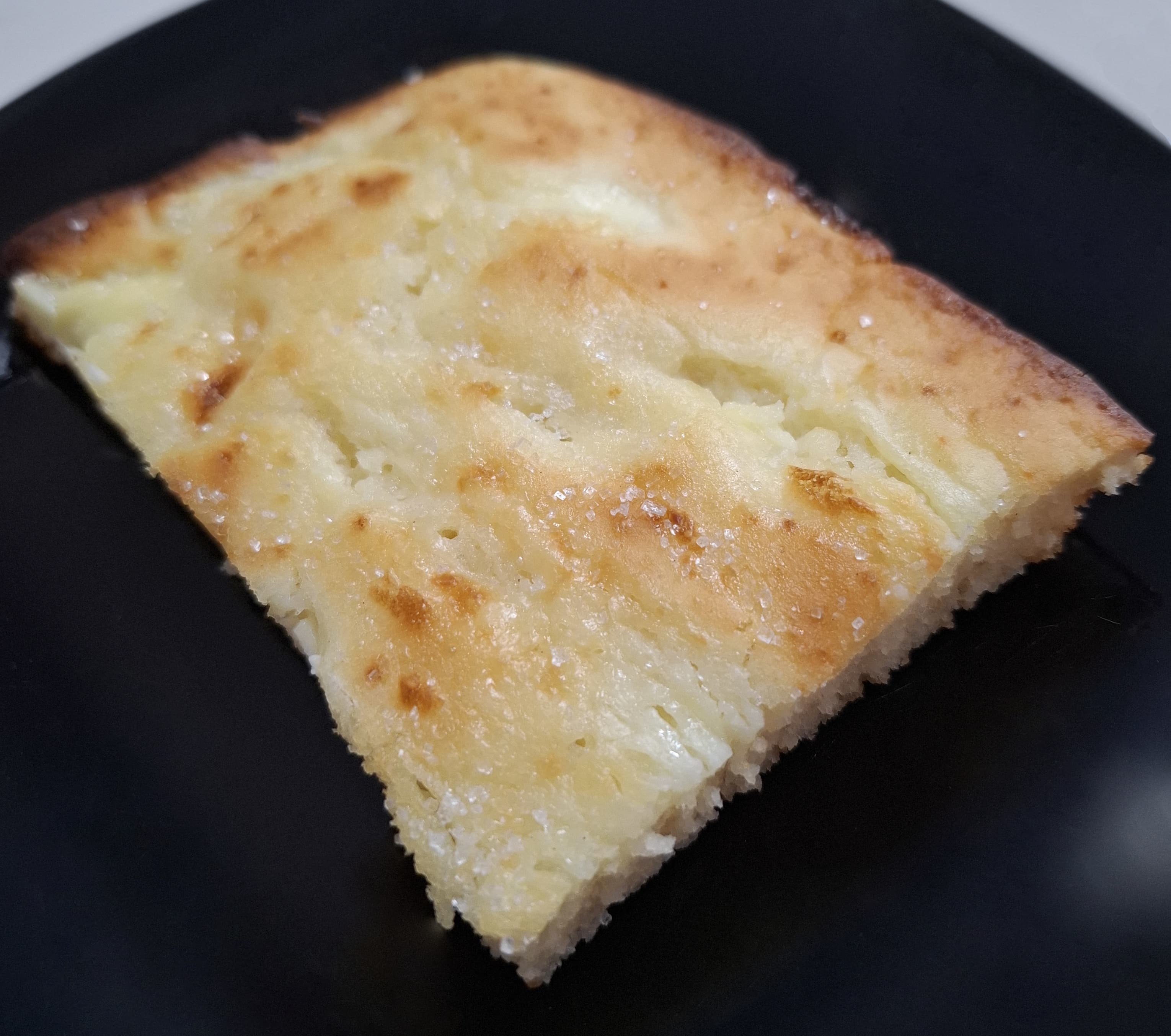 Zlevanka — a croatian dessert dish from Croatia — featuring poured-and-baked, corn-based, dual-sweet-salty